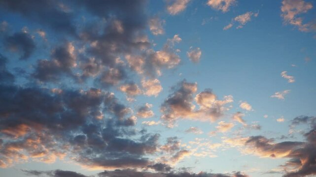 Evening sky transforms with breathtaking clouds shifting colors as the sun sets. This enchanting video footage reveals the dynamic beauty of twilight and changing light