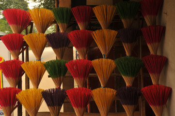 Colorful incense sticks in rows for sale.