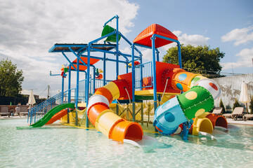 Colorful water slides and play structure inviting children to aquatic fun