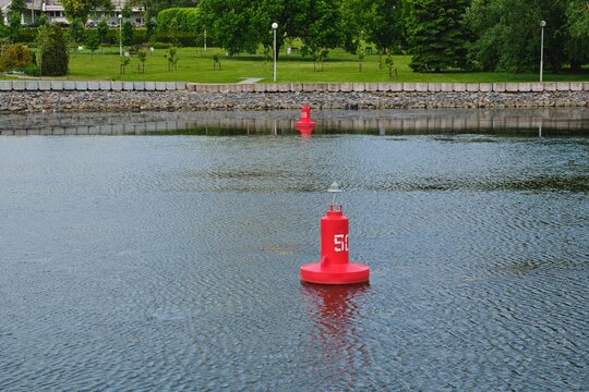 Red buoy with a lamp and the number 50 to mark the fairway on the river.