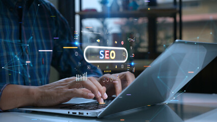 Person uses a laptop with various digital SEO icons and graphs overlaid, symbolizing online marketing and search engine optimization.