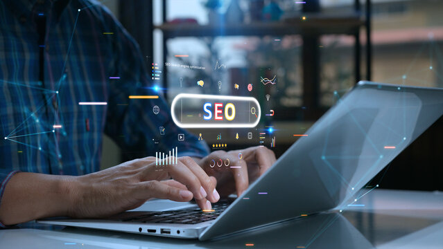 Person uses a laptop with various digital SEO icons and graphs overlaid, symbolizing online marketing and search engine optimization.