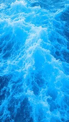 Fototapeta premium Swirling blue waves with white foam