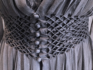 Close up of black vintage smocked waist chiffon dress with buttons