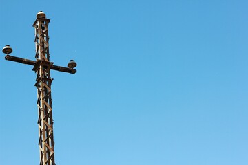 Electricity power pole on blue sky background with empty space.
