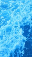 Fototapeta premium Swirling blue waves with white foam