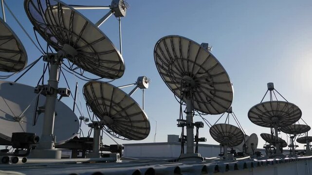 Satellite dishes on a rooftop with clear sky in urban setting showcasing technology and communication systems