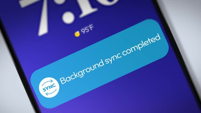 Background sync completed notification appearing on the smartphone screen in blue color, 4k footage close up. Data sync, online