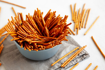 Organic Salty Pretzel Sticks in a Bowl, side view.