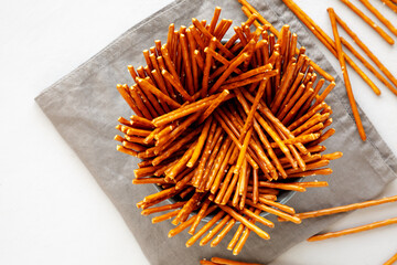 Organic Salty Pretzel Sticks in a Bowl, top view. Space for text.