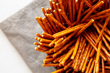 Organic Salty Pretzel Sticks in a Bowl, top view. Copy space.