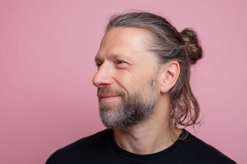 Fototapeta premium headshot of a man with a ponytail, pastel color background