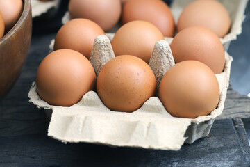 A close-up view of a stack of eggs neatly arranged in a carton on table.