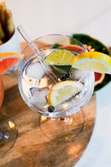 Gin and tonic cocktail with juniper seasoning and lime and lemon
