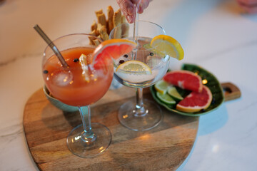 Cocktails with snacks, gin and tonic, wodka and juice