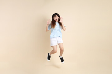 20s Asian Woman in Light Blue Shirt and White Shorts