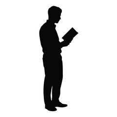 Silhouette of a man standing and reading a book in profile view