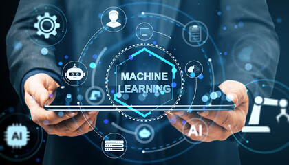 Machine learning concept with futuristic digital interface icons surrounding tablet held by businessman on dark background with glowing tech elements.