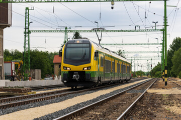 Obraz premium Modern electric train arriving at rural railway station 