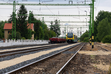 Electric passenger train approaching through railway junction
