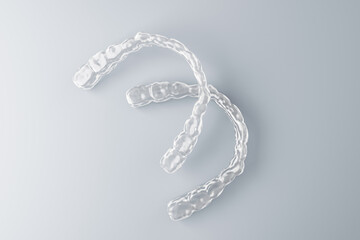 Transparent dental aligners on light gradient background for modern orthodontic medicine concept, isolated with clean empty space design. 3D Rendering