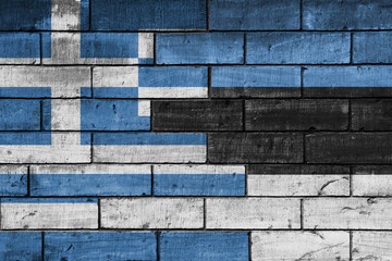 colourful painted big national flag of estonia and flag of greece on a massive old brick wall background. concept