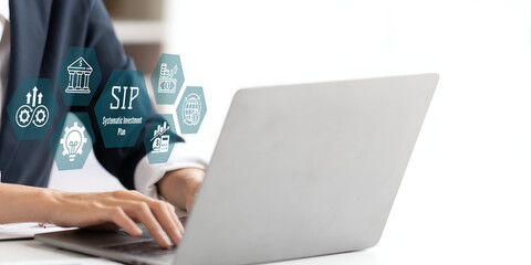 A business person using laptop with SIP Systematic Investment Plan concept.