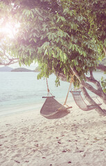 Hammocks on the beach of a tropical island, color toning applied, Philippines.
