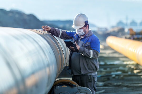 Inspector is checking welds with ultrasonic test method. It is a family of non-destructive testing techniques based on the propagation of ultrasonic waves in the object or material tested.