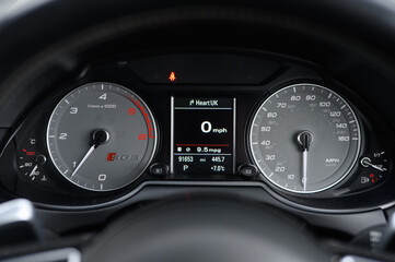 The dashboard of a car shows the speedometer at 0 mph