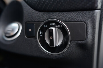 A car dashboard with a button that says Auto