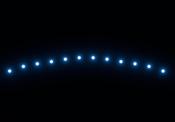 Spotlights of bright blue light on black background