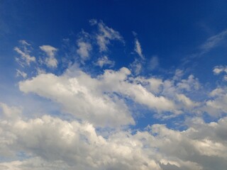 Expansive Blue Sky with Fluffy Cumulus Clouds