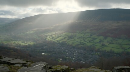 Sunlight over hills and small town