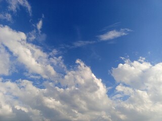 Expansive Blue Sky with Fluffy Cumulus Clouds