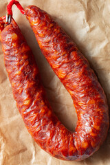 Spanish Chorizo spicy sausage on a brown paper bag background. Environmentally friendly eco biodegradable packaging concept.