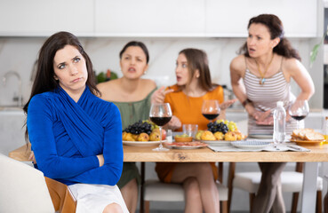 Portrait of an upset brunette woman who quarreled with her friends at a party