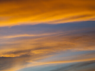 Golden twilight sky with faint cloud streaks.Color-splashed at sunset with warm hues. 