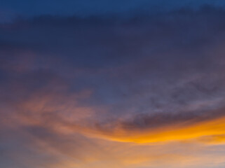 Golden twilight sky with faint cloud streaks.Color-splashed at sunset with warm hues. 