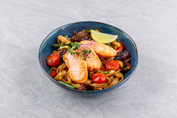 Grilled Salmon Rice Noodles with Roasted Vegetables and Lime Wedge