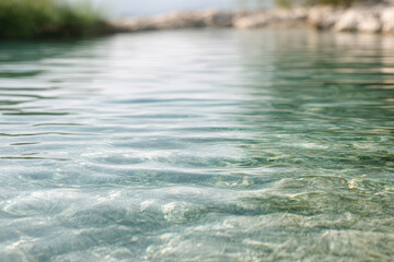 Fototapeta premium crystal clear water in serene pool reflecting soft morning light