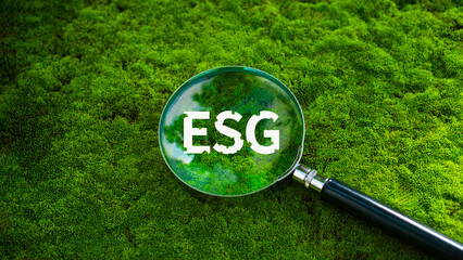 The ESG concept of environment, society and governance, in the middle of a magnifying glass with the word ESG to represent the contribution to solving global environmental problems.