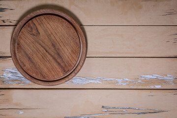 Round cutting board placed top left on rustic vintage table
