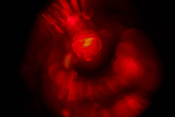 Abstract red lens flare effect on black background for design. Random color and light shapes.