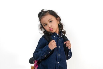 A cute little Asian girl posing with her school bag. Back to school concept.