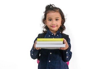 A little Asian girl wearing her school bag and carrying a stack of books