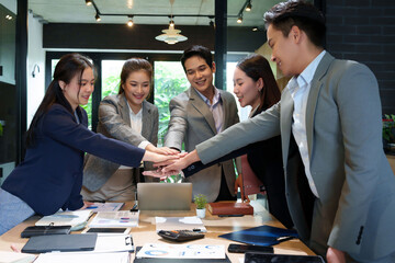 Asian Business Team Stacking Hands in Meeting for Collaboration Teamwork Unity Success with Happy...