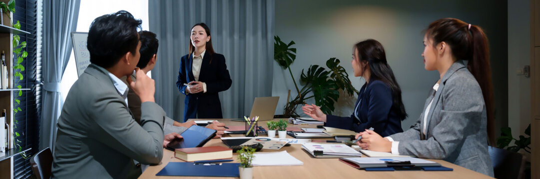 Asian Business Women Leading Corporate Meeting Presentation with Diverse Team for Strategy Brainstorming and Collaboration in Modern Office Environment - Powered by Adobe
