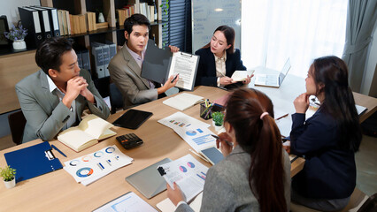 Business Meeting Asian Team Collaboration on Project Planning Strategy and Financial Data Analysis...