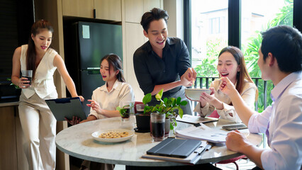 Asian Business Team Enjoying Snack Break During Meeting Young Adults Smiling Sharing Food at Office...